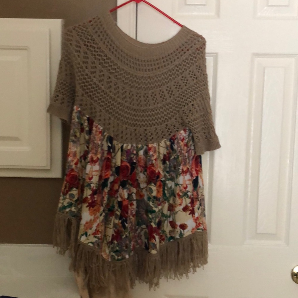 A tan and floral sweater or blouse